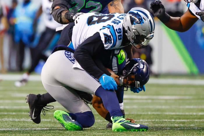 Carolina Panthers defensive end Marquis Haynes Sr. (98) sacks Seattle Seahawks quarterback Geno Smith (7) during the fourth quarter at Lumen Field.